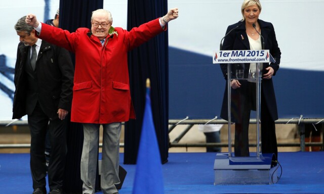 (FILES) This file photo taken on May 01, 2015 shows France's far-right political party Front National (FN) founder and honorary president Jean-Marie Le Pen gesturing on stage as FN's president Marine Le Pen looks during the party's annual rally in honour of Jeanne d'Arc (Joan of Arc), in Paris.
Front National (National Front - FN) leader Marine Le Pen arrived slightly behind the pro-European centrist candidate with 21.53 percent of the votes in the first round of France's Presidential election on April 23, 2017.
/ AFP PHOTO / KENZO TRIBOUILLARD